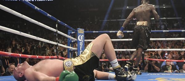 Tyson Fury lies prostrate on the canvas in the final round of Saturday's fight with Deontay Wilder in Los Angeles Tyson Fury lies prostrate on the canvas in the final round of Saturday's fight with Deontay Wilder in Los Angeles - Sputnik International
