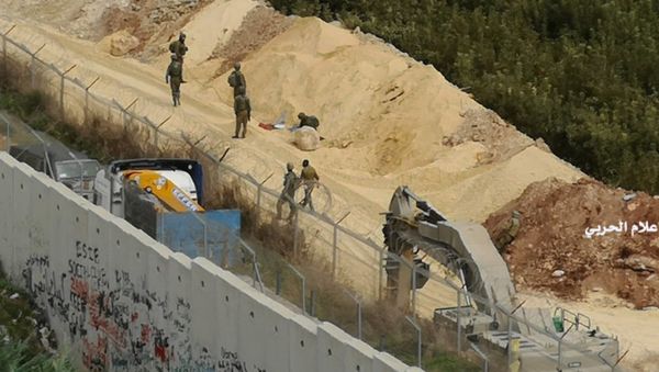 In this photo released by Hezbollah Central Military Media, Israeli military digger work on the Lebanese-Israeli border next to a wall that was built by Israel in the southern village of Kafr Kila, Lebanon on Tuesday, Dec. 4, 2018. - Sputnik International