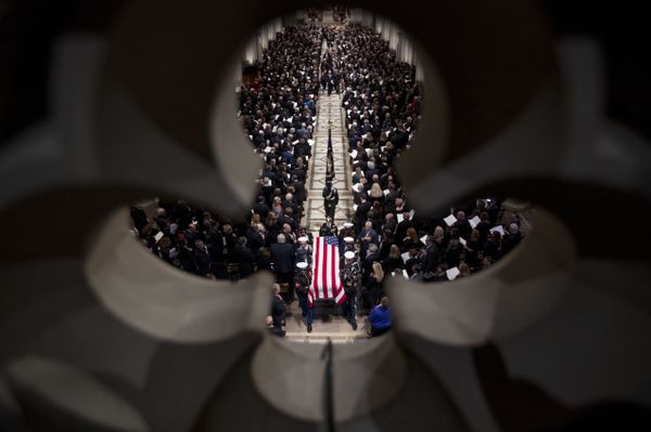 The flag-draped casket of former President George H.W. Bush is carried out by a military honor guard during a State Funeral at the National Cathedral The flag-draped casket of former President George H.W. Bush is carried out by a military honor guard during a State Funeral at the National Cathedral - Sputnik International