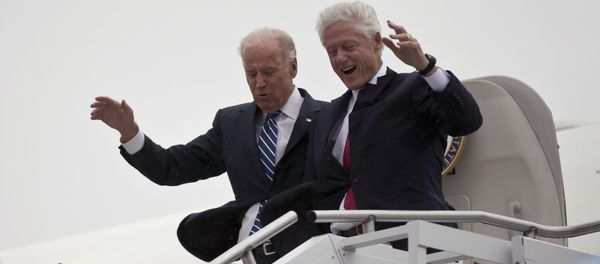 Vice President Joe Biden, left, accompanied by former President Bill Clinton walk carefully off Air Force Two during a rainstorm,, upon their arrival in Youngstown, Ohio, for a campaign stop, Monday, Oct. 29, 2012. - Sputnik International