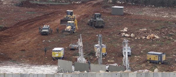 An Israeli military digger works on the Lebanese-Israeli border next to a wall that was built by Israel in the southern village of Kafr Kila, Lebanon, Tuesday, Dec. 4, 2018. - Sputnik International