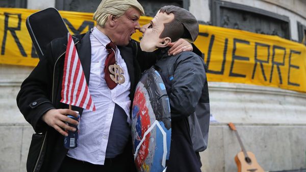 People wearing a Donald Trump mask, left, and an Emmanuel Macron mask act up for the cameras during an anti-Trump gathering in Republique square in Paris, Sunday Nov. 11, 2018 People wearing a Donald Trump mask, left, and an Emmanuel Macron mask act up for the cameras during an anti-Trump gathering in Republique square in Paris, Sunday Nov. 11, 2018 - Sputnik International