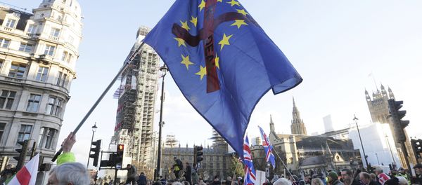 Demonstrators hold placards and flags at the Brexit Betrayal Rally, a pro-Brexit rally, outside the Houses of Parliament in London, Sunday Dec. 9, 2018 - Sputnik International