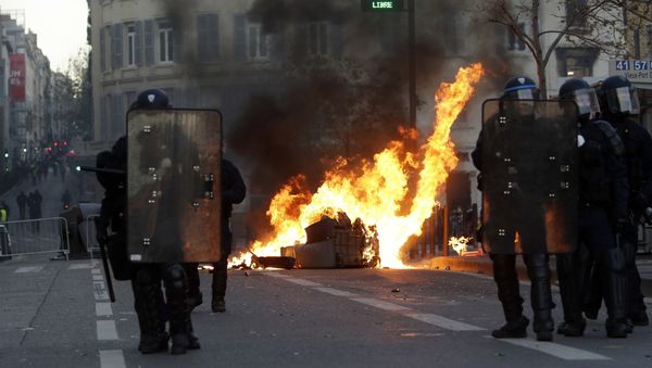 Riot police officer stand in front a burning trash bin during clashes, Saturday, Dec. 8, 2018 in Marseille, southern France - Sputnik International