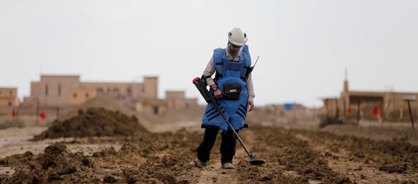 A man holds a device to detect mines in an area recently cleared of mines and unexploded ordnance in a project to clear the area near Qasr Al-Yahud, a traditional baptism site along the Jordan River, near Jericho in the occupied West Bank, December 9, 2018 A man holds a device to detect mines in an area recently cleared of mines and unexploded ordnance in a project to clear the area near Qasr Al-Yahud, a traditional baptism site along the Jordan River, near Jericho in the occupied West Bank, December 9, 2018 - Sputnik International