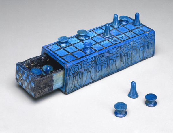 Gaming Board Inscribed for Amenhotep III with Separate Sliding Drawer, ca. 1390-1353 B.C.E. Faience, glazed, 2 3/16 x 3 1/16 x 8 1/4 in. (5.5 x 7.7 x 21 cm). Brooklyn Museum, Charles Edwin Wilbour Fund, - Sputnik International