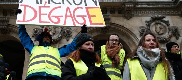 French activist Jean-Baptiste Redde, aka Voltuan, wearing a yellow vest (gilet jaune) holds a cardboard reading Macron go away during a demonstration in front of the Opera House in Paris against rising costs of living blamed on high taxes, on December 15, 2018 French activist Jean-Baptiste Redde, aka Voltuan, wearing a yellow vest (gilet jaune) holds a cardboard reading Macron go away during a demonstration in front of the Opera House in Paris against rising costs of living blamed on high taxes, on December 15, 2018 - Sputnik International