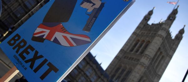 A demonstrator holds a placard during an anti-Brexit protest opposite the Houses of Parliament in London, Britain, December 17, 2018 A demonstrator holds a placard during an anti-Brexit protest opposite the Houses of Parliament in London, Britain, December 17, 2018 - Sputnik International