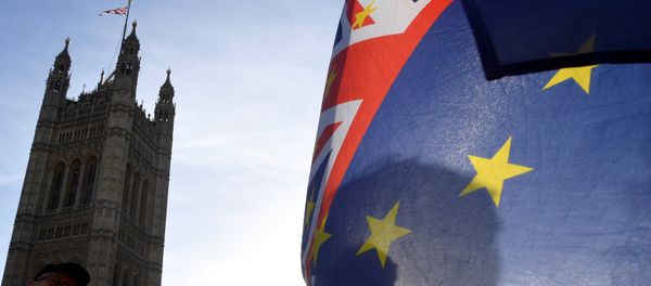 A demonstrator holds EU and Union flags during an anti-Brexit protest opposite the Houses of Parliament in London, Britain, December 17, 2018 A demonstrator holds EU and Union flags during an anti-Brexit protest opposite the Houses of Parliament in London, Britain, December 17, 2018 - Sputnik International