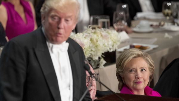 Republican presidential candidate Donald Trump, left, accompanied by Democratic presidential candidate Hillary Clinton, right, speaks at the 71st annual Alfred E. Smith Memorial Foundation Dinner, a charity gala organized by the Archdiocese of New York, Thursday, Oct. 20, 2016, at the Waldorf Astoria hotel in New York - Sputnik International