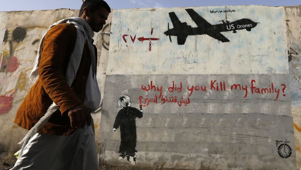 A man walks past a graffiti, denouncing strikes by U.S. drones in Yemen, painted on a wall in Sanaa, Yemen on November 13, 2014 - Sputnik International