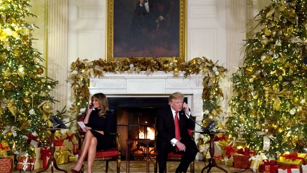 U.S. President Donald Trump and first lady Melania Trump participate in NORAD Santa tracker phone calls from the White House in Washington, U.S. December 24, 2018 - Sputnik International