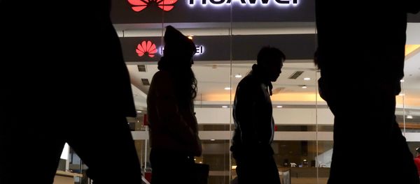 Pedestrians walk past a Huawei retail shop in Beijing Thursday, Dec. 6, 2018 Pedestrians walk past a Huawei retail shop in Beijing Thursday, Dec. 6, 2018 - Sputnik International