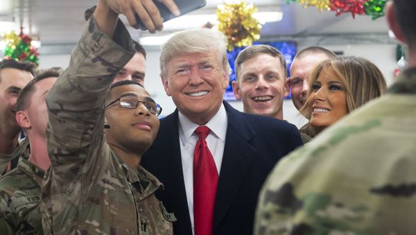 US President Donald Trump and First Lady Melania Trump greet members of the US military during an unannounced trip to Al Asad Air Base in Iraq on December 26, 2018 - Sputnik International