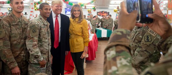 US President Donald Trump and First Lady Melania Trump take photos with members of the US military during an unannounced trip to Al Asad Air Base in Iraq on December 26, 2018 US President Donald Trump and First Lady Melania Trump take photos with members of the US military during an unannounced trip to Al Asad Air Base in Iraq on December 26, 2018 - Sputnik International
