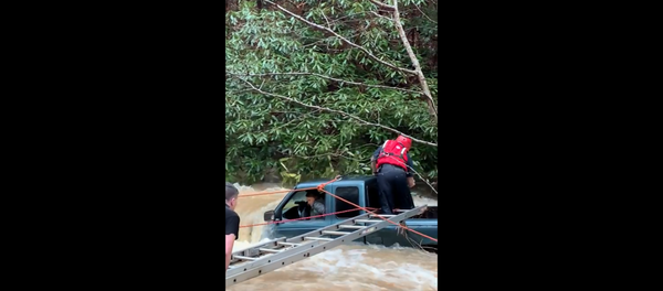 First responders in Tennessee work to rescue woman and child from a swollen creek. First responders in Tennessee work to rescue woman and child from a swollen creek. - Sputnik International