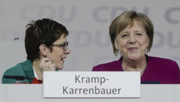 German Chancellor Angela Merkel, right, talks with CDU party chairwoman Annegret Kramp-Karrenbauer, left, during a party convention of the Christian Democratic Party CDU in Hamburg, Germany, Saturday, Dec. 8, 2018 German Chancellor Angela Merkel, right, talks with CDU party chairwoman Annegret Kramp-Karrenbauer, left, during a party convention of the Christian Democratic Party CDU in Hamburg, Germany, Saturday, Dec. 8, 2018 - Sputnik International