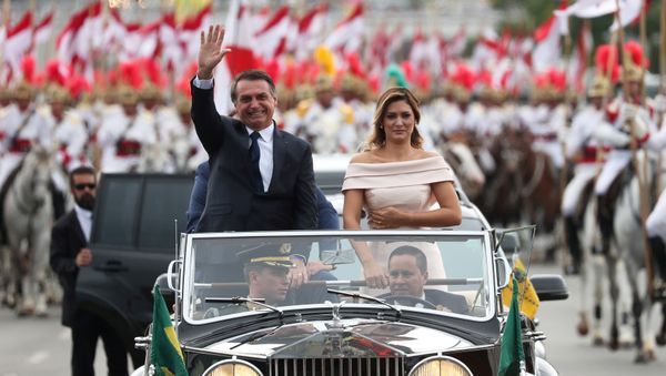 Brazil's new President Jair Bolsonaro waves as he drives past before his swear-in ceremony - Sputnik International