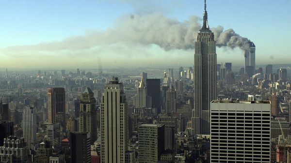 Plumes of smoke pour from the World Trade Center buildings in New York Tuesday, Sept. 11, 2001. Planes crashed into the upper floors of both World Trade Center towers minutes apart Tuesday in a horrific scene of explosions and fires that left gaping holes in the 110-story buildings - Sputnik International