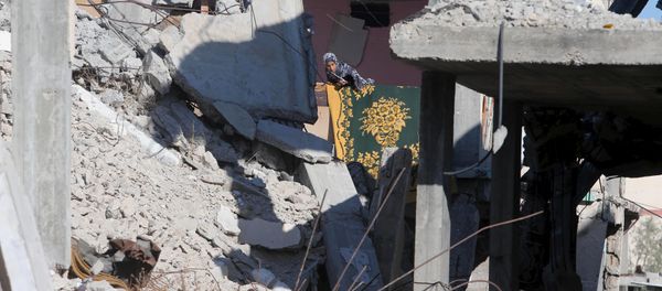 A Palestinian girl looks out from her family's house that witnesses said was destroyed by Israeli shelling during a 50-day war last summer, in Khan Younis in the southern Gaza Strip June 22, 2015. - Sputnik International