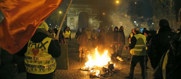 Demonstrators wearing yellow vests stands next to a burning bicycle at the Champs Elysees avenue during a protest in Paris, Saturday, Jan. 5, 2019. - Sputnik International