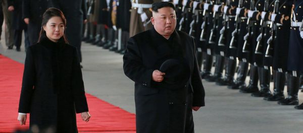 North Korean leader Kim Jong Un and wife Ri Sol Ju inspect an honour guard before leaving Pyongyang for a visit to China, this January 7, 2019 photo released by North Korea's Korean Central News Agency (KCNA) in Pyongyang January 8, 2019. - Sputnik International
