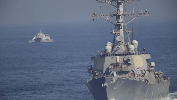 The USS Mitscher, part of a strike group led by the USS John C. Stennis aircraft carrier, sails as an Iranian Revolutionary Guard vessel shadows it on Friday, Dec. 21, 2018 - Sputnik International