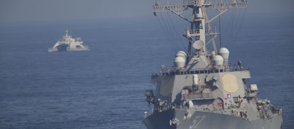 The USS Mitscher, part of a strike group led by the USS John C. Stennis aircraft carrier, sails as an Iranian Revolutionary Guard vessel shadows it on Friday, Dec. 21, 2018 - Sputnik International