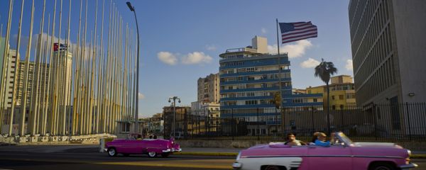Jan. 12, 2017 file photo, tourists ride in classic American convertible cars past the United States embassy, right, in Havana, Cuba Jan. 12, 2017 file photo, tourists ride in classic American convertible cars past the United States embassy, right, in Havana, Cuba - Sputnik International