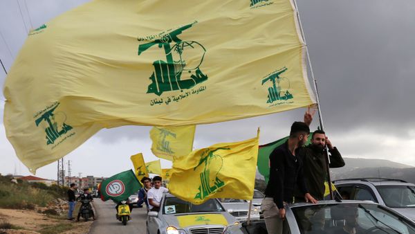 A supporter of Lebanon's Hezbollah gestures as he holds a Hezbollah flag in Marjayoun, Lebanon May 7, 2018 - Sputnik International