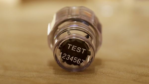 In this Dec. 12, 2016, file photo, an example of a sample bottle lid from the latest Berlinger Special BEREG-Kit for human urine doping testing lies posed for photographs in London. The Swiss manufacturer of the bottles used around the world to hold doping control samples says it is pulling out of the niche industry. Berlinger's withdrawal from the market poses a major headache for anti-doping agencies, who are now scrambling to find alternative suppliers - Sputnik International