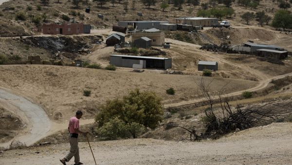 In this May 12, 2015 file photo, a Bedouin man walks through the village of Umm Al-Hiran in the Israeli Negev desert - Sputnik International