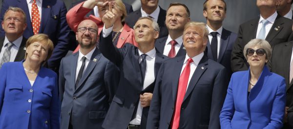 German Chancellor Angela Merkel, Belgian Prime Minister Charles Michel, NATO Secretary-General Jens Stoltenberg, U.S. President Donald Trump and British Prime Minister Theresa May, front row from left, watch a fly-by during a summit of heads of state and government at NATO headquarters in Brussels Wednesday, July 11, 2018. NATO leaders gather in Brussels for a two-day summit to discuss Russia, Iraq and their mission in Afghanistan. German Chancellor Angela Merkel, Belgian Prime Minister Charles Michel, NATO Secretary-General Jens Stoltenberg, U.S. President Donald Trump and British Prime Minister Theresa May, front row from left, watch a fly-by during a summit of heads of state and government at NATO headquarters in Brussels Wednesday, July 11, 2018. NATO leaders gather in Brussels for a two-day summit to discuss Russia, Iraq and their mission in Afghanistan. - Sputnik International