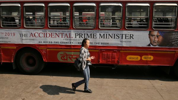 A woman walks past a bus featuring an advertising of the upcoming Bollywood film The Accidental Prime Minister in Mumbai, India, January, 5, 2019 A woman walks past a bus featuring an advertising of the upcoming Bollywood film The Accidental Prime Minister in Mumbai, India, January, 5, 2019 - Sputnik International