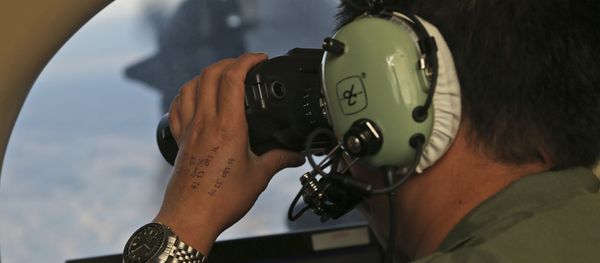 In this March 22, 2014, file photo, Flight Officer Jack Chen uses binoculars at an observers window on a Royal Australian Air Force P-3 Orion during the search for missing Malaysia Airlines Flight MH370 in Southern Indian Ocean, Australia In this March 22, 2014, file photo, Flight Officer Jack Chen uses binoculars at an observers window on a Royal Australian Air Force P-3 Orion during the search for missing Malaysia Airlines Flight MH370 in Southern Indian Ocean, Australia - Sputnik International
