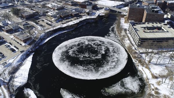 In this Monday, Jan. 14, 2019 aerial image taken from a drone video and provided by the City of Westbrook, Maine, a naturally occurring ice disk forms on the Presumpscot River in Westbrook, Maine. - Sputnik International