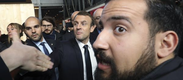 In this picture dated Feb. 24, 2017 French president Emmanuel Macron, center, visits the 55th International Agriculture Fair at the Porte de Versailles exhibition center in Paris, France, as Elysee senior security officer Alexandre Benalla, right, looks on In this picture dated Feb. 24, 2017 French president Emmanuel Macron, center, visits the 55th International Agriculture Fair at the Porte de Versailles exhibition center in Paris, France, as Elysee senior security officer Alexandre Benalla, right, looks on - Sputnik International