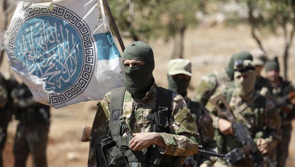 Syrian fighters attend a mock battle in anticipation of an attack by the regime on Idlib province and the surrounding countryside, during a graduation of new Hayat Tahrir al-Sham (HTS) members at a camp in the countryside of the northern Idlib province on August 14, 2018 - Sputnik International