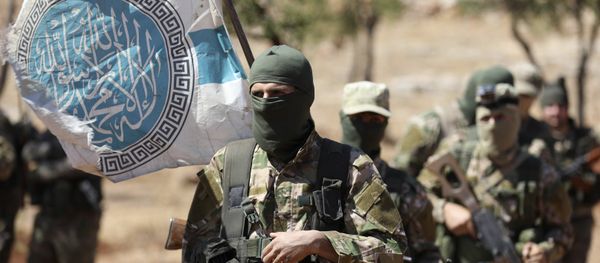 Syrian fighters attend a mock battle in anticipation of an attack by the regime on Idlib province and the surrounding countryside, during a graduation of new Hayat Tahrir al-Sham (HTS) members at a camp in the countryside of the northern Idlib province on August 14, 2018 - Sputnik International