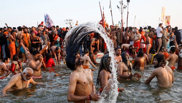 Naga Sadhus or Hindu holy men take a dip during the first Shahi Snan (grand bath) at Kumbh Mela or the Pitcher Festival, in Prayagraj, previously known as Allahabad, India, January 15, 2019 - Sputnik International
