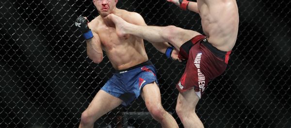 Russia's Khabib Nurmagomedov kicks Al Iaquinta during the fourth round of title bout at UFC 223 - Sputnik International