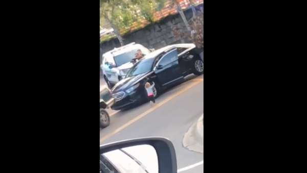 Cellphone footage shows toddler walking toward Florida police officers with arms raised during her father's arrest - Sputnik International