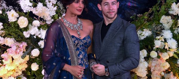 Indian Bollywood actress Priyanka Chopra (L) and US musician Nick Jonas, who were recently married, pose for a picture during a reception in Mumbai on December 19, 2018 Indian Bollywood actress Priyanka Chopra (L) and US musician Nick Jonas, who were recently married, pose for a picture during a reception in Mumbai on December 19, 2018 - Sputnik International