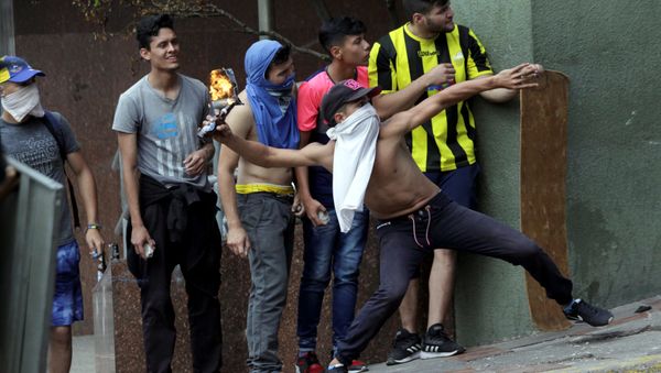 Demonstrators clash with security forces while participating in a rally against Venezuelan President Nicolas Maduro's government and to commemorate the 61st anniversary of the end of the dictatorship of Marcos Perez Jimenez in Tachira, Venezuela Demonstrators clash with security forces while participating in a rally against Venezuelan President Nicolas Maduro's government and to commemorate the 61st anniversary of the end of the dictatorship of Marcos Perez Jimenez in Tachira, Venezuela - Sputnik International