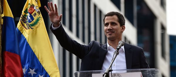 Venezuela's National Assembly head Juan Guaido waves to the crowd during a mass opposition rally against leader Nicolas Maduro in which he declared himself the country's acting president, on the anniversary of a 1958 uprising that overthrew military dictatorship, in Caracas on January 23, 2019. - Sputnik International