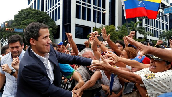 Juan Guaido, President of Venezuela's National Assembly, greets supporters during a rally against Venezuelan President Nicolas Maduro's government and to commemorate the 61st anniversary of the end of the dictatorship of Marcos Perez Jimenez in Caracas, Venezuela January 23, 2019 Juan Guaido, President of Venezuela's National Assembly, greets supporters during a rally against Venezuelan President Nicolas Maduro's government and to commemorate the 61st anniversary of the end of the dictatorship of Marcos Perez Jimenez in Caracas, Venezuela January 23, 2019 - Sputnik International