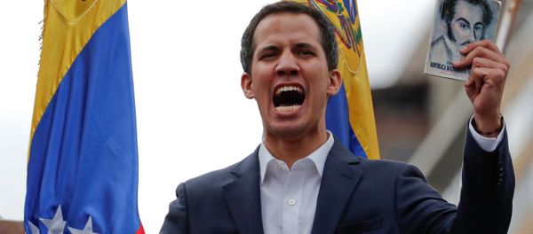 Juan Guaido, President of Venezuela's National Assembly, holds a copy of Venezuelan constitution during a rally against Venezuelan President Nicolas Maduro's government and to commemorate the 61st anniversary of the end of the dictatorship of Marcos Perez Jimenez in Caracas, Venezuela January 23, 2019 Juan Guaido, President of Venezuela's National Assembly, holds a copy of Venezuelan constitution during a rally against Venezuelan President Nicolas Maduro's government and to commemorate the 61st anniversary of the end of the dictatorship of Marcos Perez Jimenez in Caracas, Venezuela January 23, 2019 - Sputnik International