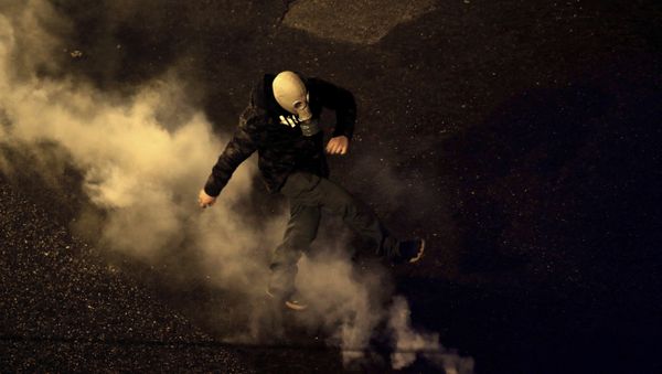 A protester kick back a tear gas canister fired by riot police during clashes following a rally by opponents of Prespa Agreement, outside the Greek Parliament in Athens, Thursday, Jan. 24, 2019 - Sputnik International