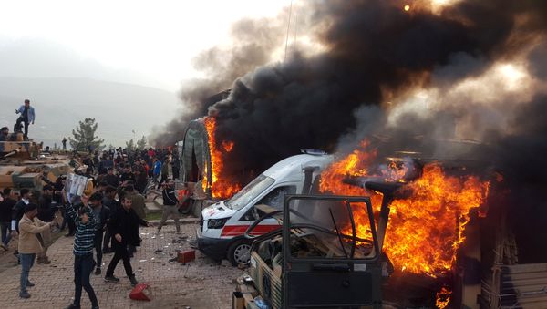 A smoke rises from vehicles after protesters stormed a Turkish military camp near Dohuk, Iraq January 26, 2019 - Sputnik International