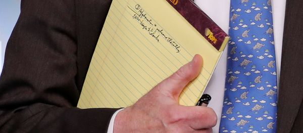 U.S. National Security Adviser John Bolton holds a writing pad with a written note that reads 5,000 troops to Colombia, while he waits to address reporters, as the Trump administration announces economic sanctions against Venezuela and the Venezuelan state owned oil company Petroleos de Venezuela (PdVSA) during a press briefing at the White House in Washington, U.S., January 28, 2019 - Sputnik International